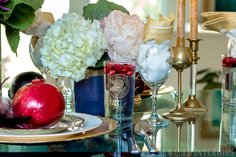 I learned so much from this 8 step tutorial on how to set a pretty tablescape! || Jeweledinteriors, jeweled interiors, party, planning, dinner, brunch, banquet, table, setting, centerpiece, placemats, napkin, pomegranate, feather, gold, salad, charger, placemat, rings, flowers, candles, vintage, dollar store, beautiful, sequin, sheepskin, texture