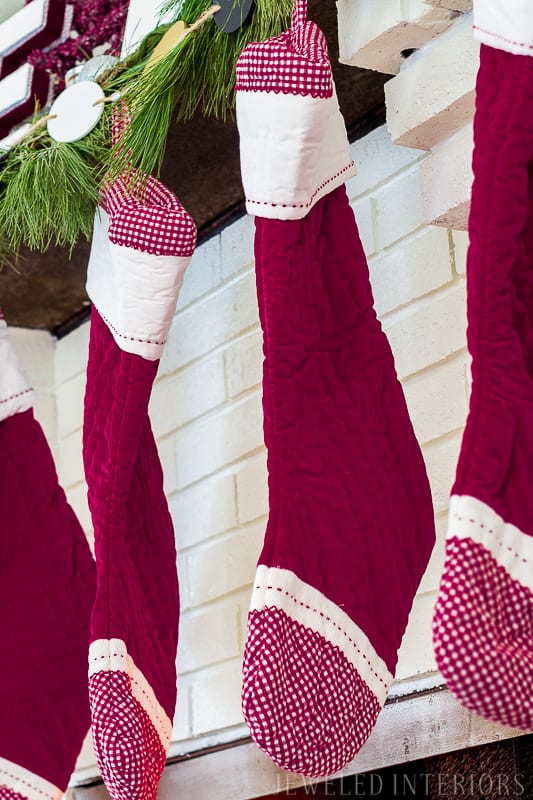 Holiday Home tour || Red pottery barn stockings, mantle, greeney, swag, HOLIDAY HOME TOUR REVEAL || THIS TREE|| Looking for inspiration for Christmas? Jeweled Interiors, Holiday, Home Tour, Burgundy, cranberry, blush, Decor, Ideas, Tips, black, Christmas, tree, decor, decorations, DIY, inspiration, red, maroon, wine, home tour, poinsettia, glam, chic, peach, gold, black, white, garland, antique, mirror