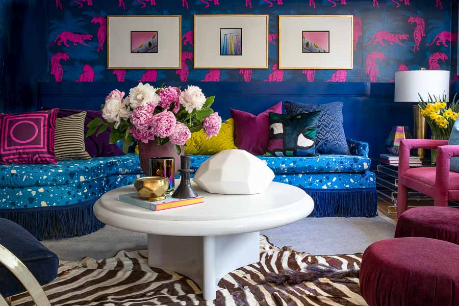 Check out this amazing Terrazzo, blue, velvet, sofa with custom fabric from Spoonflower. I can't believe those chairs were painted. I Love the Tiger wallpaper too.