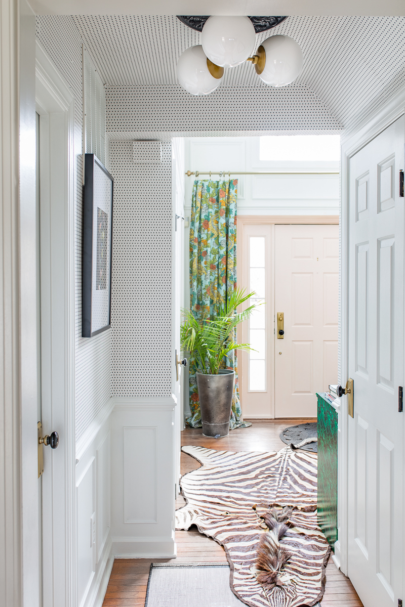 Jeweled Interiors , Fall home tour, front door with art, zebra rug, moulding