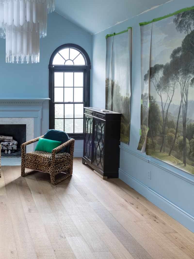 leopard chairs on lifecor flooring, Anton Fresh Aire, life core engineered hardwoods, blue walls, black trim, oversized chandelier, hardwood floors