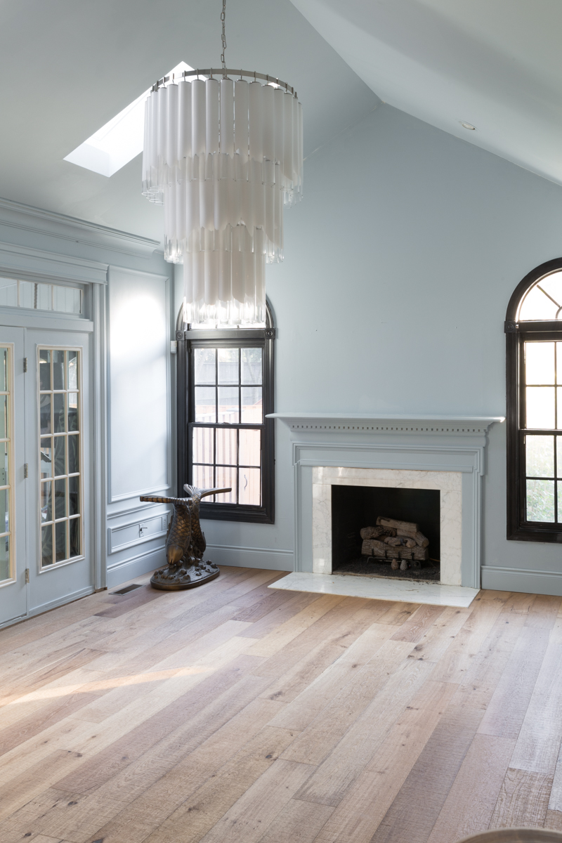 leopard chairs on lifecor flooring, Anton Fresh Aire, life core engineered hardwoods, blue walls, black trim, oversized chandelier, hardwood floors