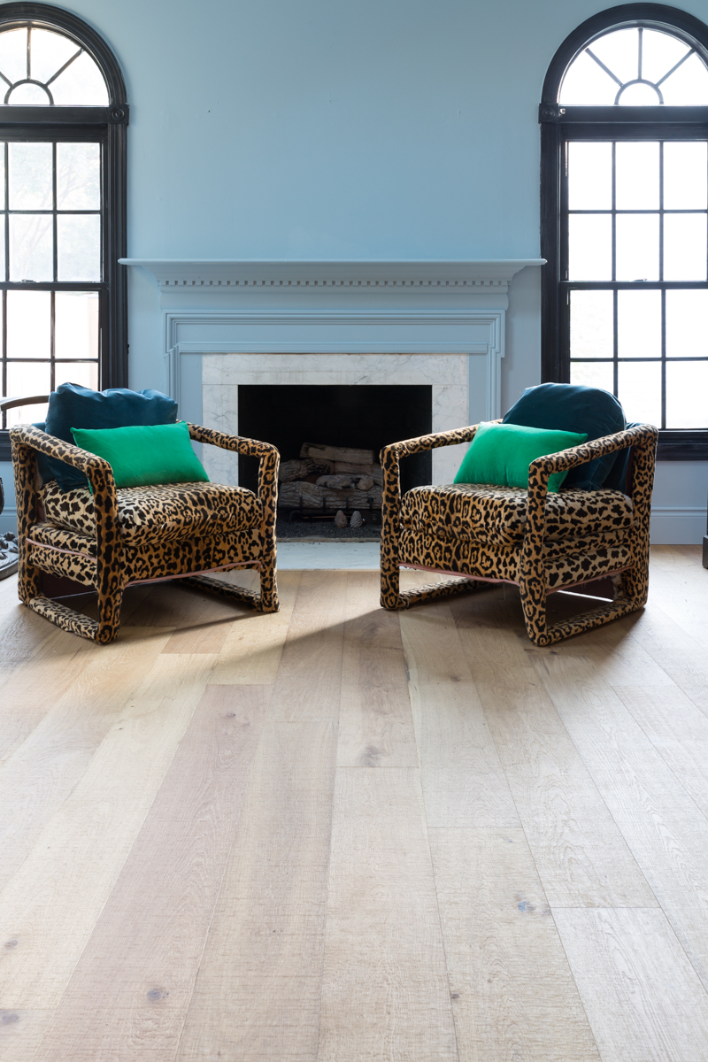 leopard chairs on lifecor flooring, Anton Fresh Aire, life core engineered hardwoods, blue walls, black trim, oversized chandelier, hardwood floors