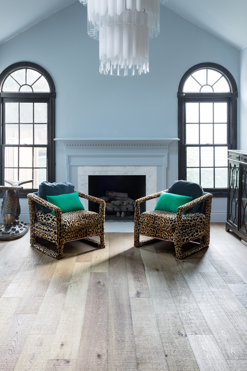 leopard chairs on lifecor flooring, Anton Fresh Aire, life core engineered hardwoods, blue walls, black trim, oversized chandelier, hardwood floors