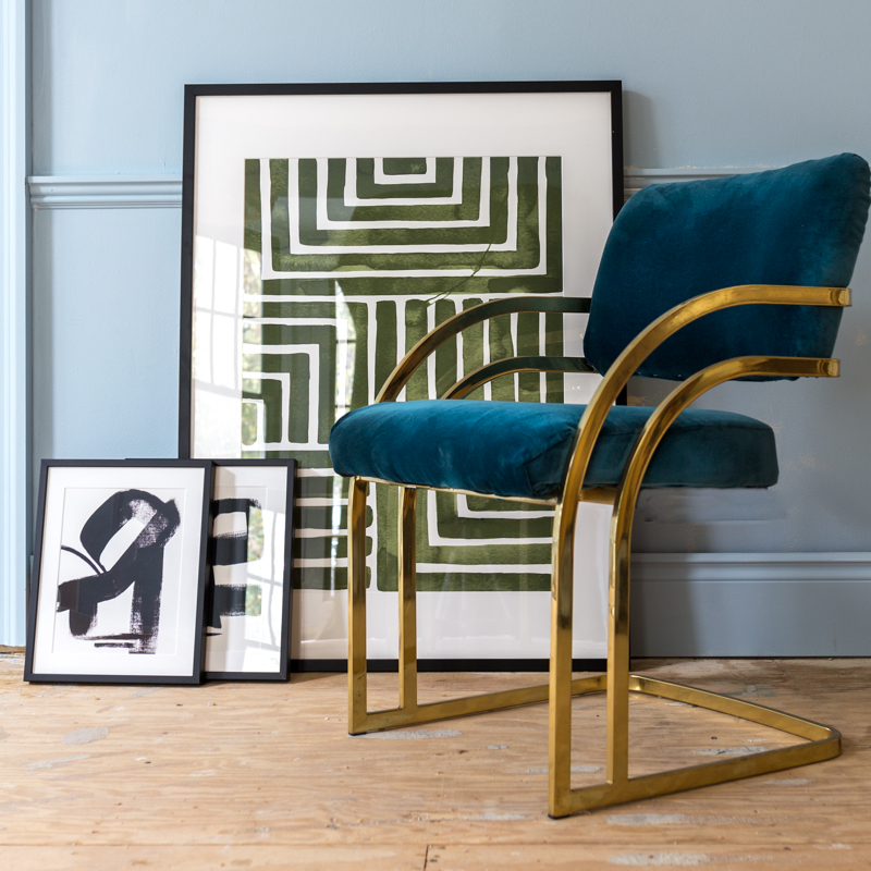 Graphic minted art and a milo baughman chair, blue walls
