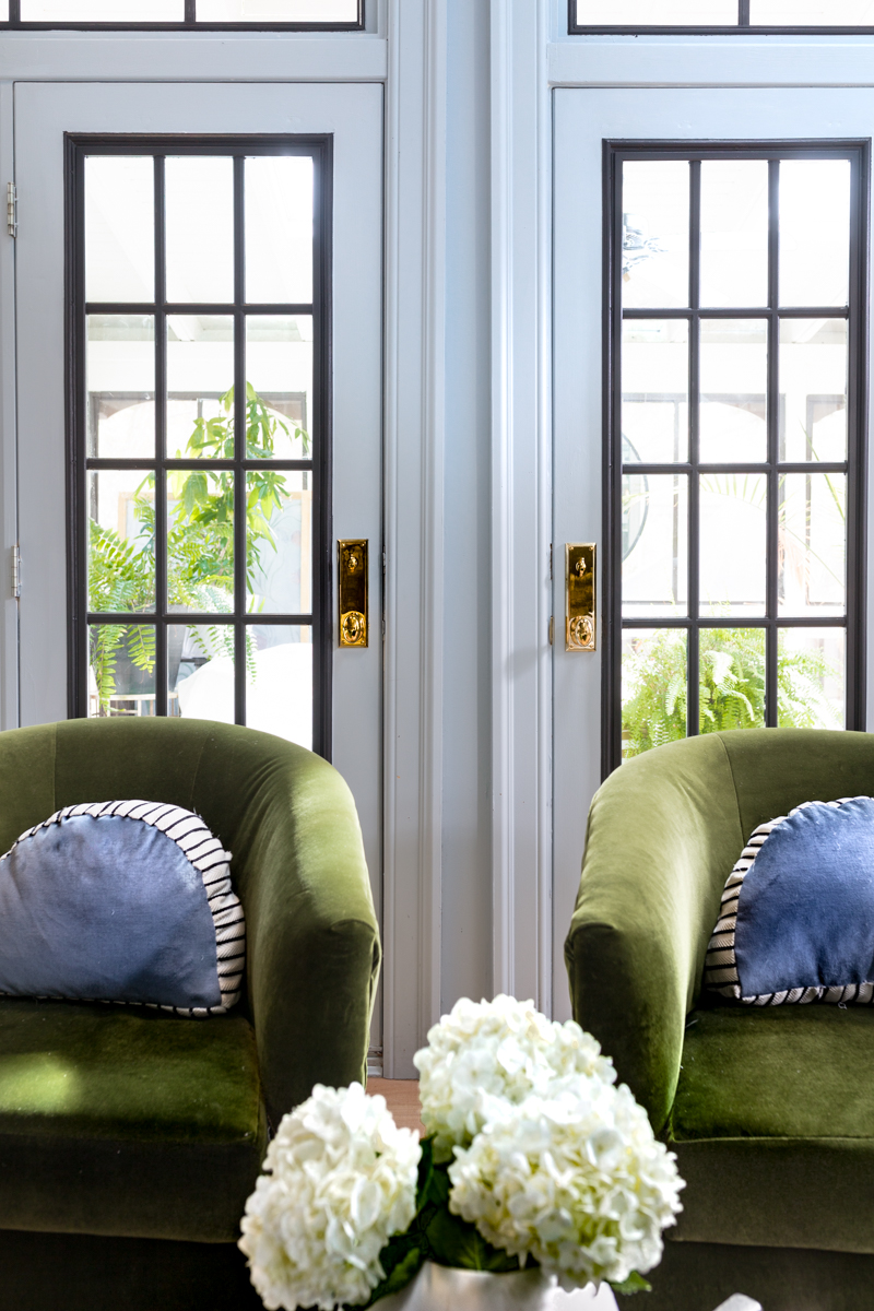 MIND BLOWING! MUST SEE THIS REVEAL! Jeweled Interiors Fall 2019 ORC, living room, green velvet chairs, Emtek door knobs, unlacquered brass, blue walls, black windows 