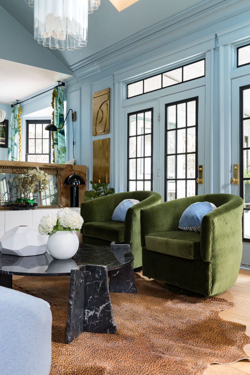 MIND BLOWING! MUST SEE THIS REVEAL! Jeweled Interiors Fall 2019 ORC, living room, lifecore flooring, Emtek handles on blue doors, leopard rug, black marble coffee table, Rothko art, mural, and statement chandelier. 