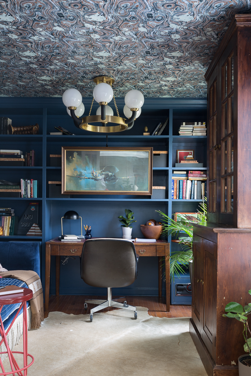 CHECK OUT this office reveal! Stiffkey blue, spoonflower, farrow and ball, Werner, Hudson valley lighting, hvlg, fringed sofa, airplane art, navy blue office, pilot's office, masculine office, navy blue office, antique desk, antique bookcase