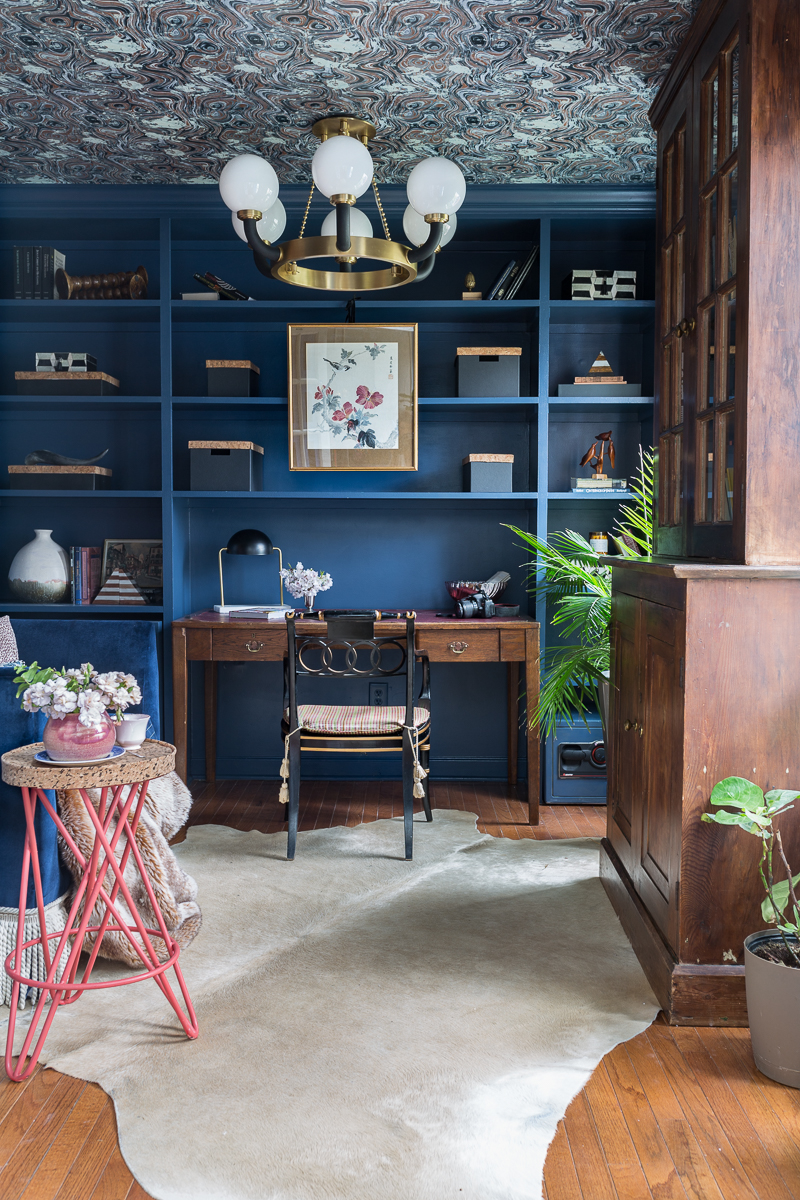 Jeweled Interiors Stiffkey Blue, Farrow and Ball, office, with built in shelves, and organization boxes, and antique desk and chair, wallpapered ceiling