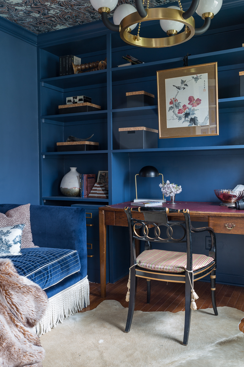 Jeweled Interiors Stiffkey Blue, Farrow and Ball, office, with built in shelves, and organization boxes, and antique desk and chair, wallpapered ceiling