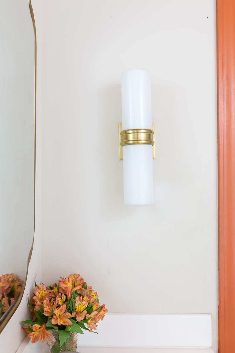 bathroom lighting, Natalie sconce, inexpensive lighting, Mitzi lighting, wall sconce, Anthropologie mirror, orange trim