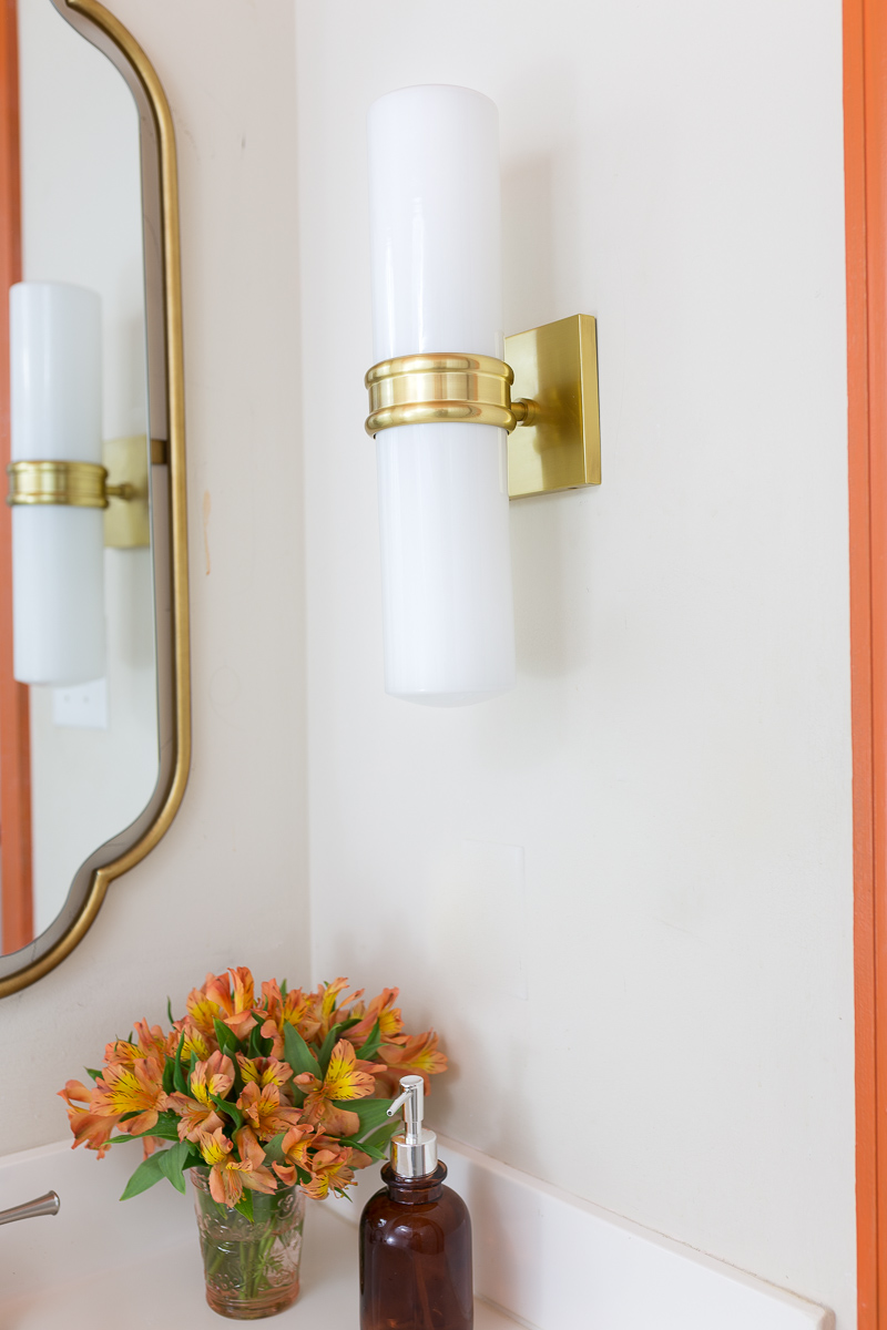 bathroom lighting, Natalie sconce, inexpensive lighting, Mitzi lighting, wall sconce, Anthropologie mirror, orange trim