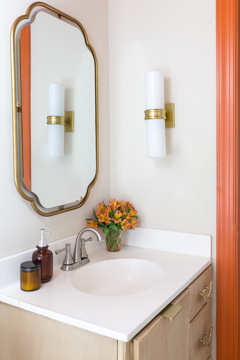 bathroom lighting, Natalie sconce, inexpensive lighting, Mitzi lighting, wall sconce, Anthropologie mirror, orange trim