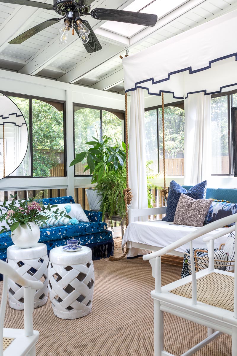 AMAZING sunroom ideas!!! mohawk rug, Montuak, canopy bed, bed swing, sun room, sunroom, budget sunroom, blue and white sunroom, terrazzo sofa, greek key