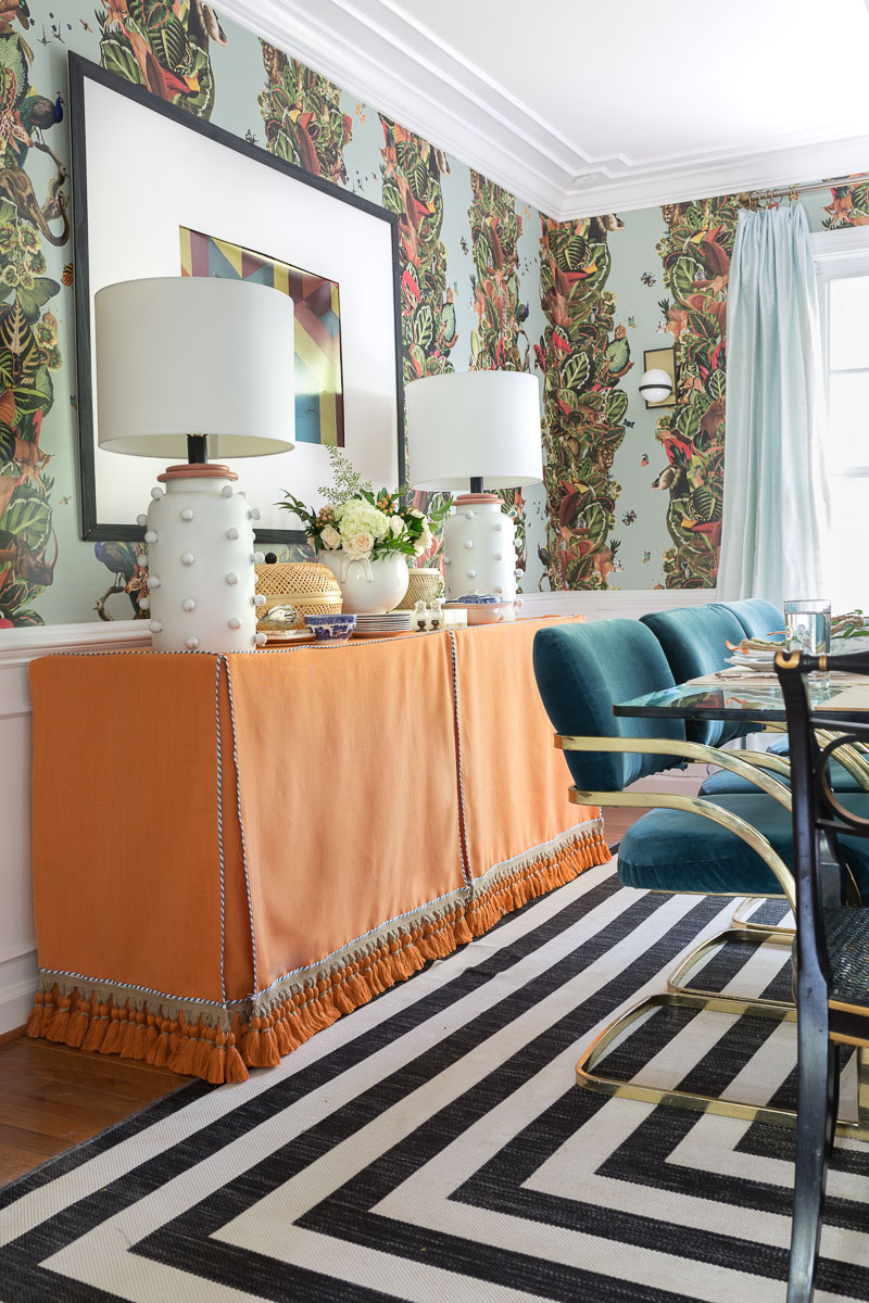 colorful home, Jewel Marlowe Home Tour, summer 2020, jeweled interiors portfolio, dining room, jungle wallpaper, black and white striped rug, orange buffet skirt