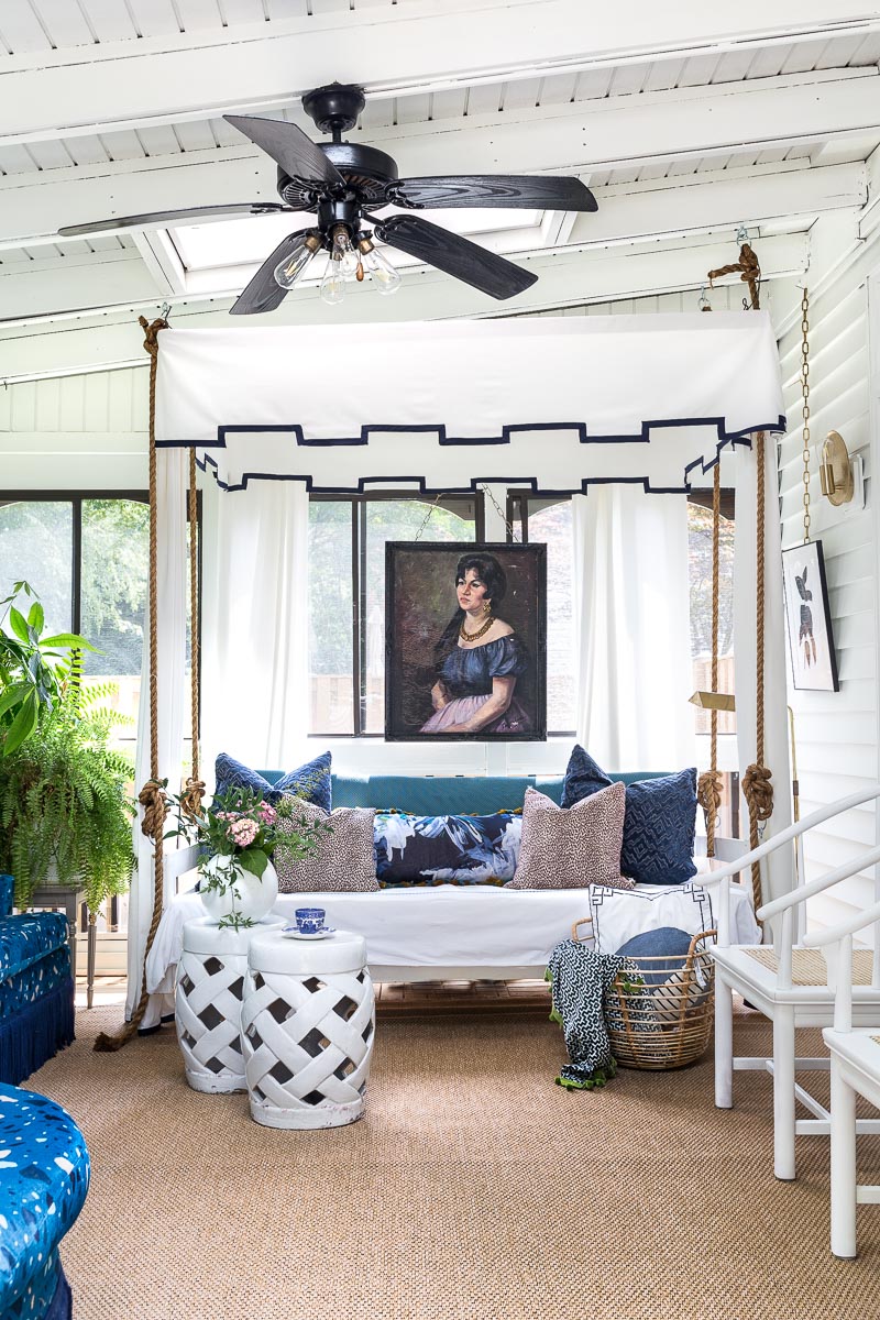 AMAZING sunroom ideas!!! mohawk rug, canopy bed, bed swing, sun room, sunroom, budget sunroom, blue and white sunroom, terrazzo sofa, greek key