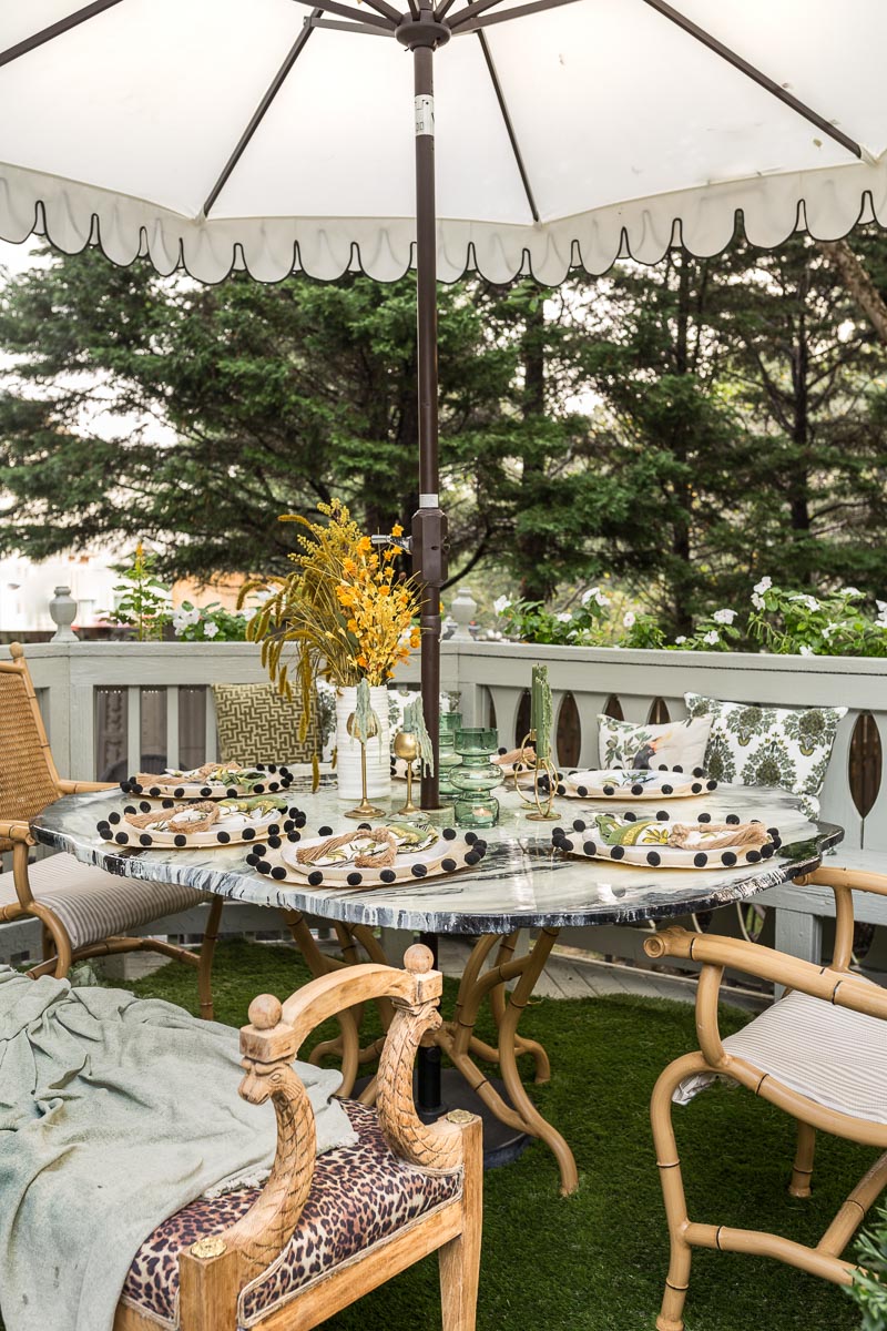 patio decorating ideas, patio ideas, artificial grass rug, antique bench, agate table, deck, entertaining, fall, bamboo chair, black and white umbrella 