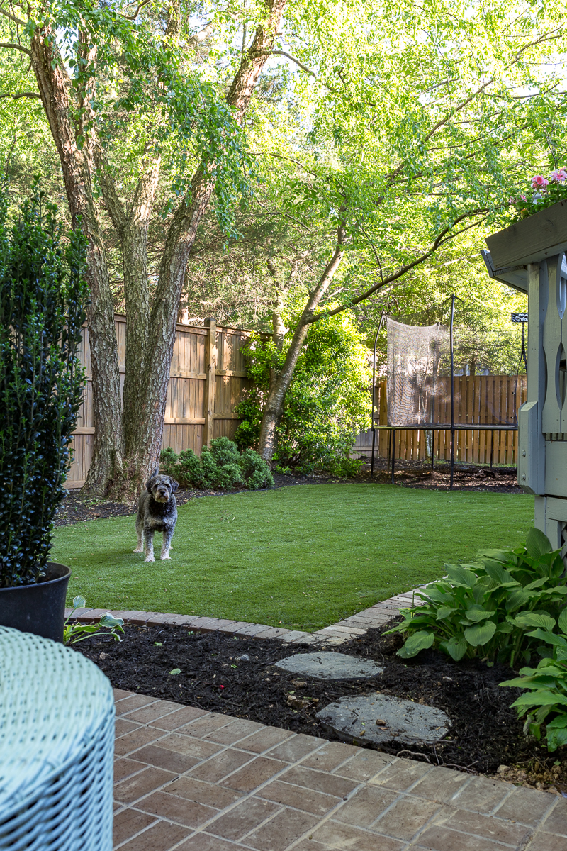 backyard ideas, backyard makeover, landscaping ideas, brick patio, patio design, outdoor furniture,  farrow and ball, Kelly Wearstler, palm, spoon flower, Holli Zollinger, Jesvita, safaviah, round sectional, black and white, bamboo coffee table, imitation grass, gravel walkway, jeweled interiors, small backyard makeover