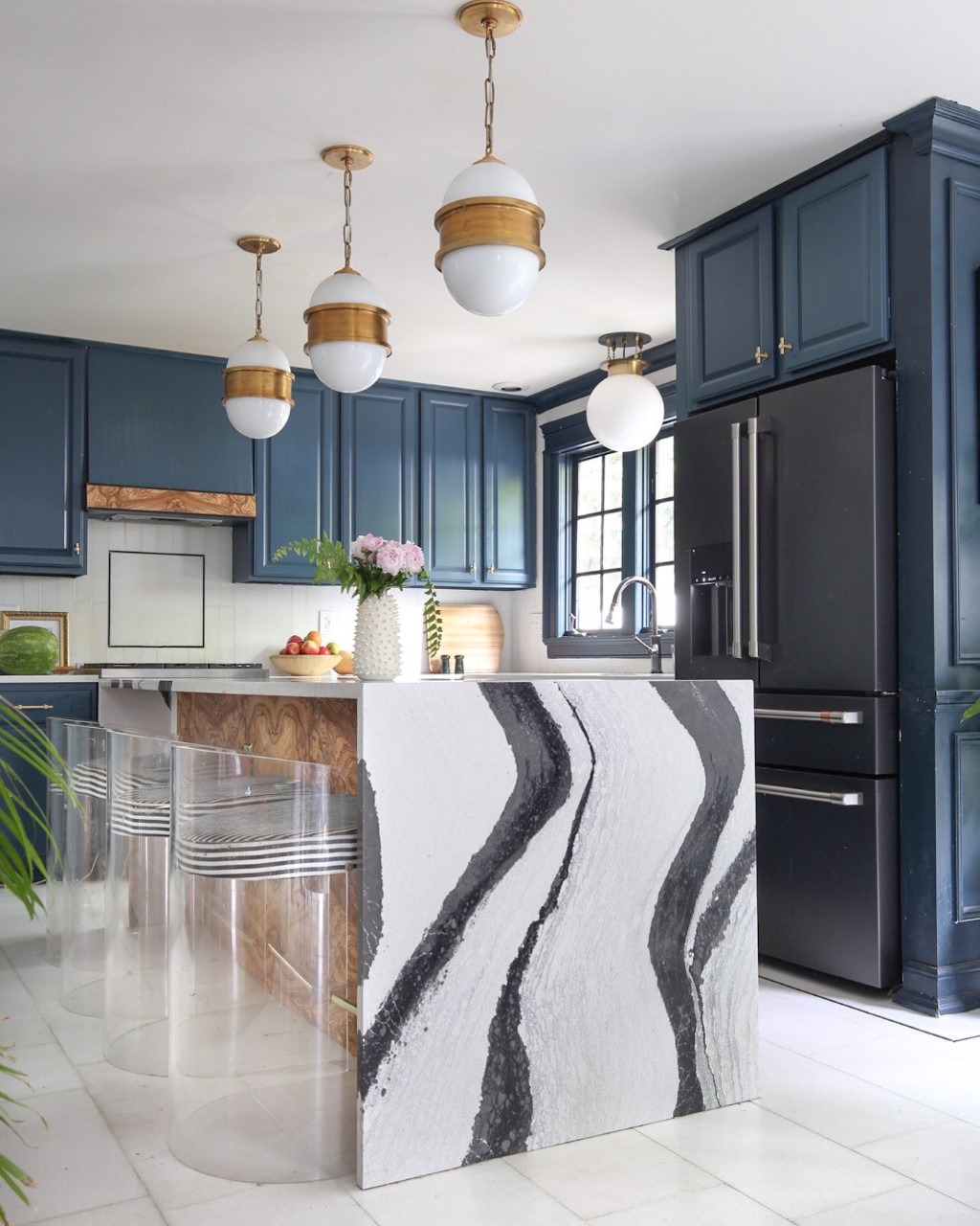 blue kitchen with black and white cambria countertop that mimics panda marble