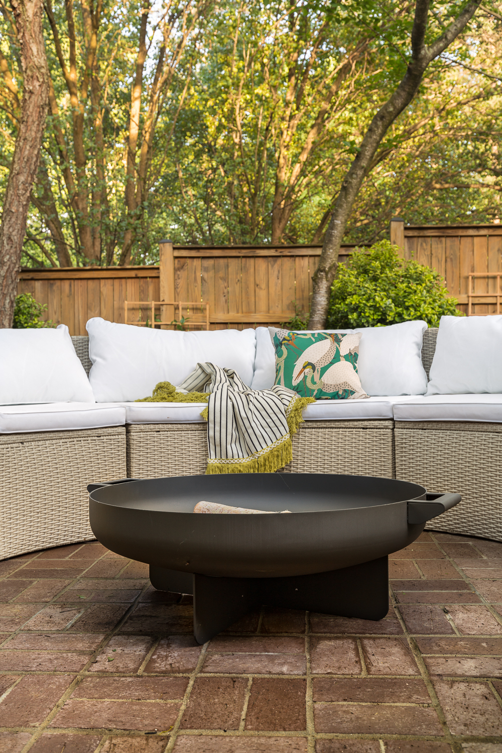 backyard ideas, backyard makeover, landscaping ideas, brick patio, patio design, outdoor furniture,  farrow and ball, Kelly Wearstler, palm, spoon flower, Holli Zollinger, Jesvita, safaviah, round sectional, black and white, bamboo coffee table, imitation grass, gravel walkway, jeweled interiors, small backyard makeover