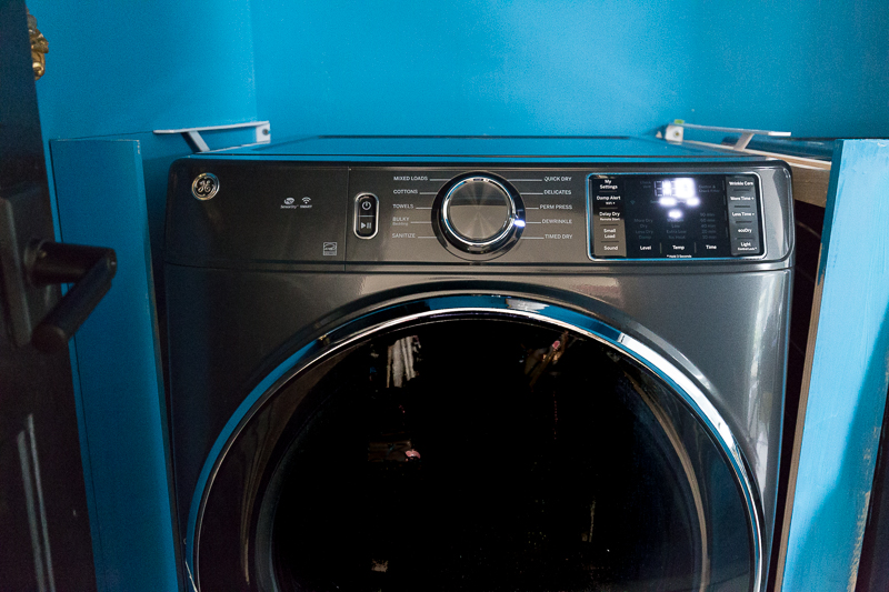 You have to see the updates to this laundry room |emtek, door knobs, lever door knob, graham and brown wallpaper, the container store, small laundry room ideas, teal, wallpaper, laundry basket, metallic wallpaper.