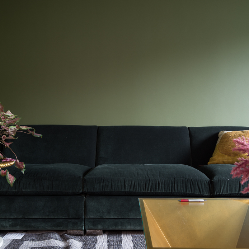 tone on tone sofa, color clashing sofa, pyramid coffee table, snake side table, green velvet sofa, one room challenge