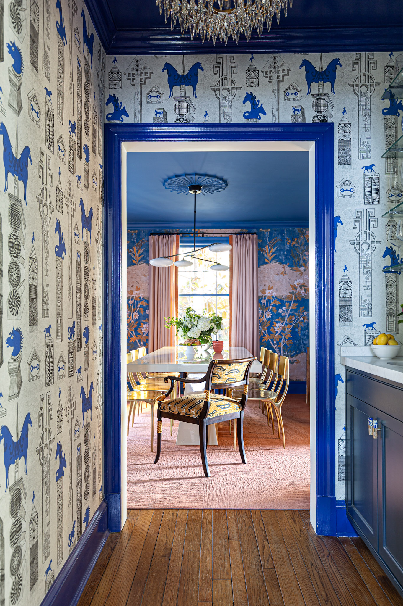 glamorous wet bar, visual comfort, glamorous flush mount, high gloss paint, blue, jennifer shorto wallpaper, marble countertop, custom brass shelving, view to dramatic dining room, chinoiserie<br />
